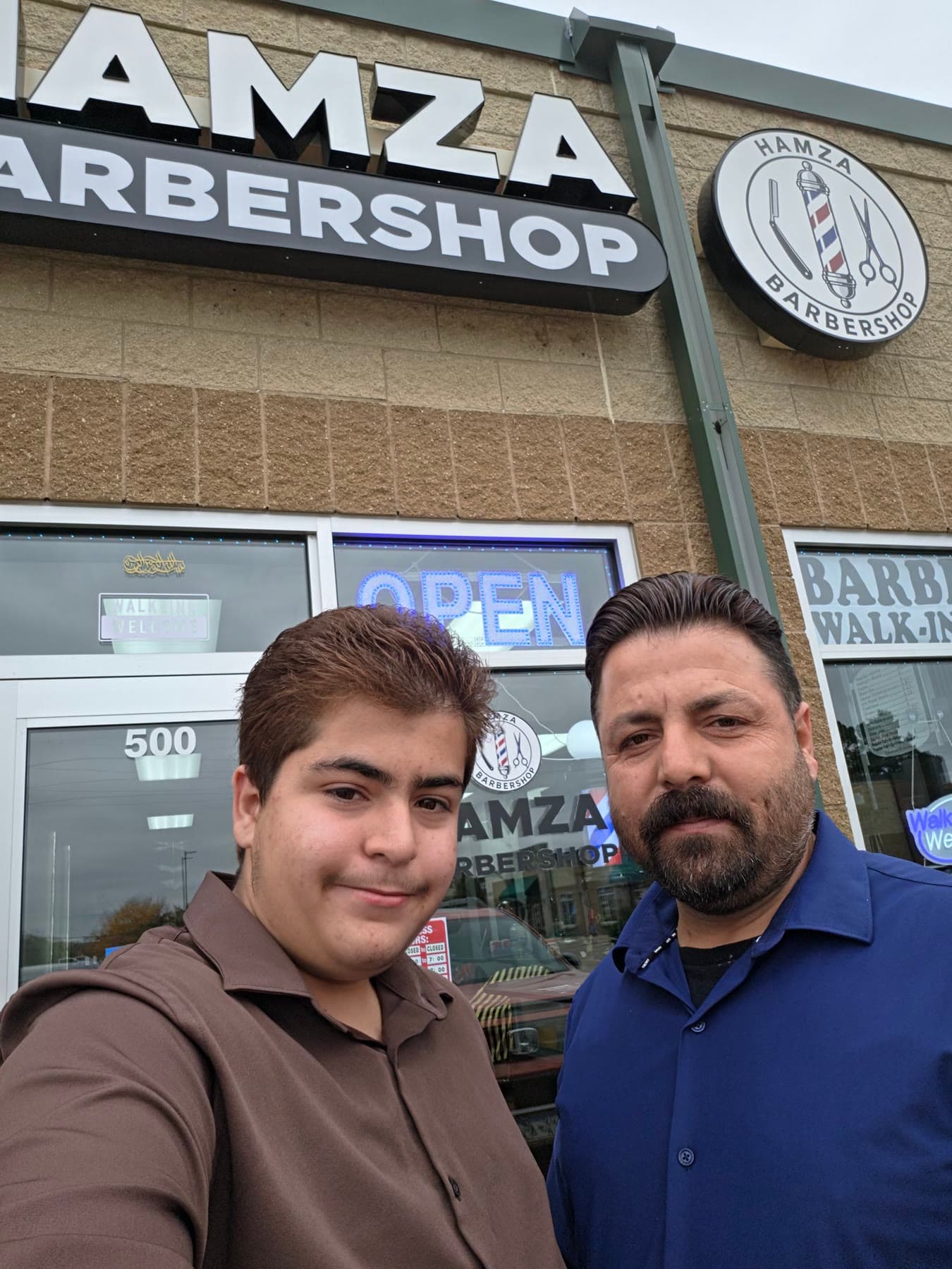 Ryad and Hamza outside the shop