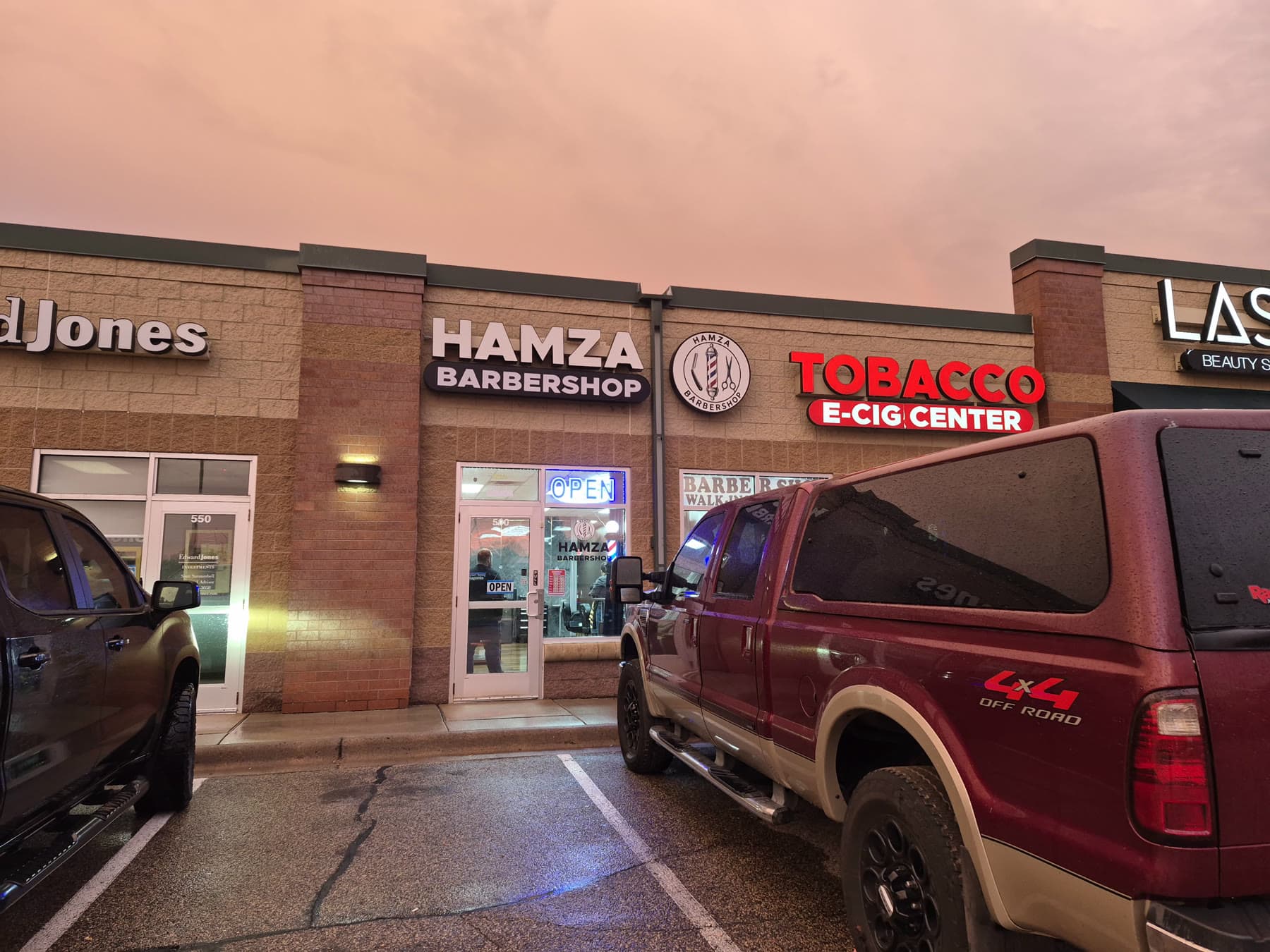 Hamza Barbershop under a red sunset sky